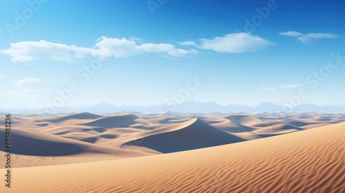  a desert landscape with sand dunes and mountains in the distance with a blue sky and white clouds in the background.
