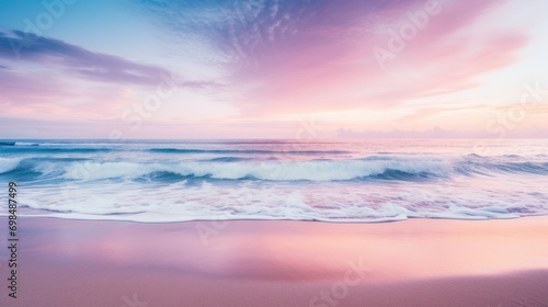  a view of a beach with waves coming in to the shore and a pink sky with clouds in the background. © Olga