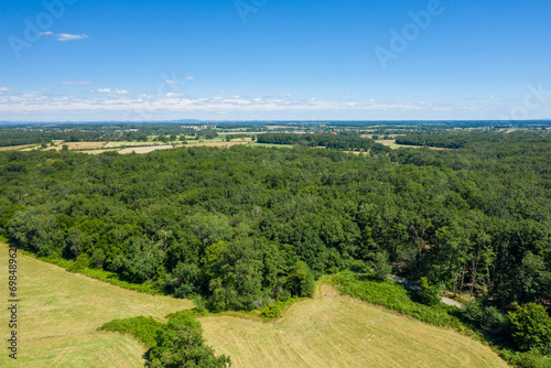 The green countryside with its forests and fields in Europe, France, Burgundy, Nievre, towards Nevers, in summer, on a sunny day. © Florent