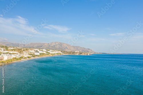 The paradise coast and the sandy beach at the foot of the mountains, in Europe, Greece, Crete, Analipsi, By the Mediterranean Sea, in summer, on a sunny day.