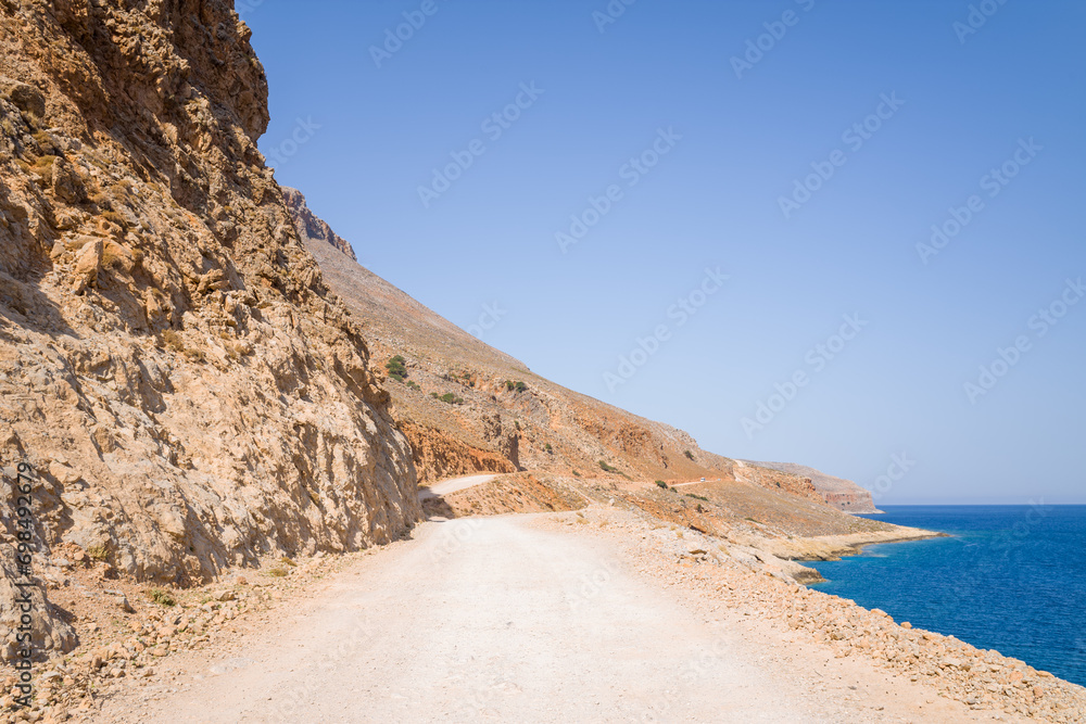 The road leading to the paradise sandy beach , in Europe, Greece, Crete, Balos, By the Mediterranean Sea, in summer, on a sunny day. The road leading to the paradise sandy beach , in Europe, Greece, Crete, Balos, By the Mediterranean Sea, in summer, on a sunny day.