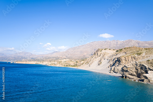 The rocky coast and its arid cliffs , in Europe, Greece, Crete, Agios Pavlos, By the Mediterranean Sea, in summer, on a sunny day.