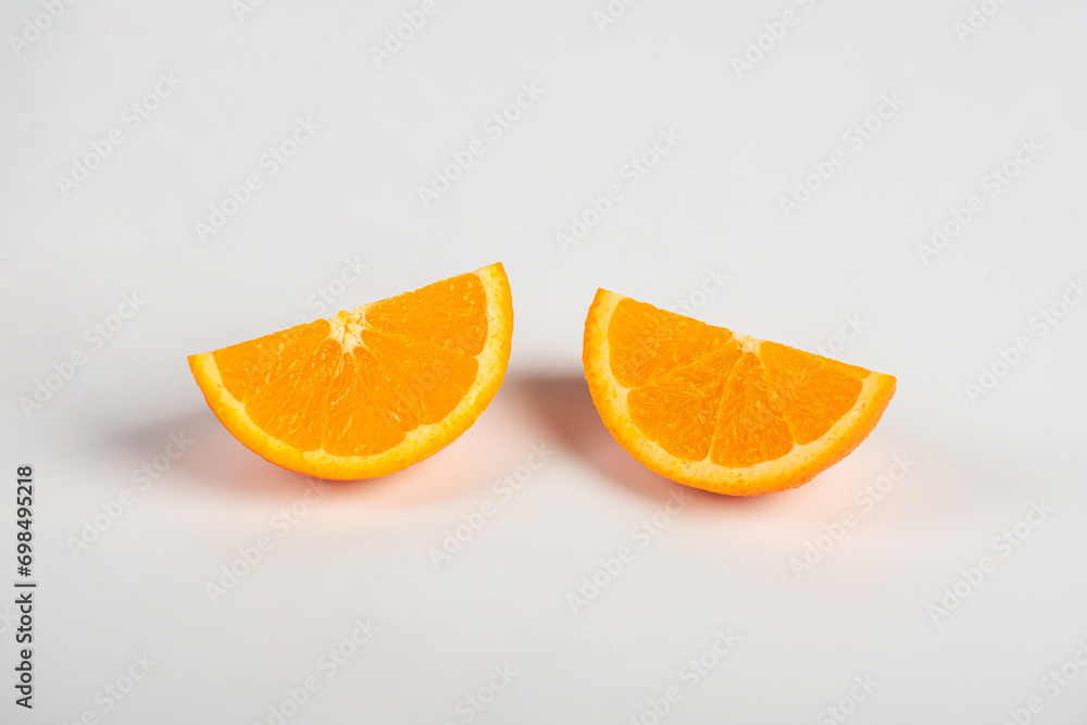 Fototapeta premium Orange slice isolate. Orange fruit half and slice set on white background.