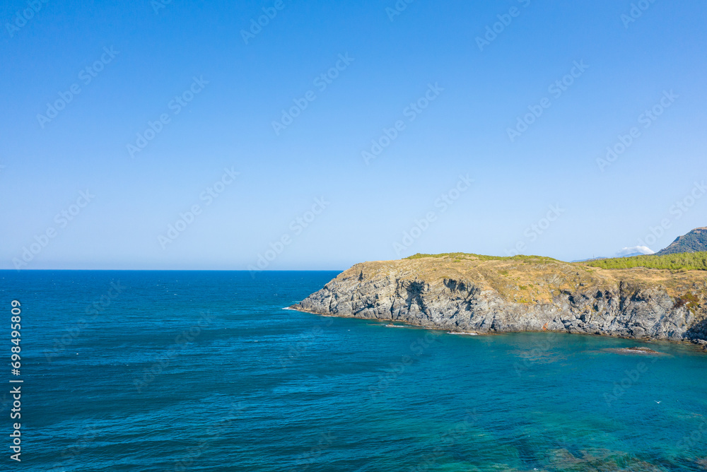 The arid rocky coast in Europe, France, Occitanie, Pyrenees Orientales, Banyuls-sur-Mer, By the Mediterranean Sea, in summer, on a sunny day.