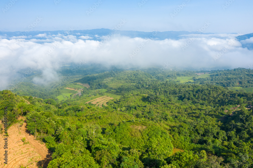 The clouds above the city seen from the green mountains , in Asia, Vietnam, Tonkin, Dien Bien Phu, in summer, on a sunny day.