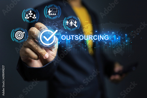 Fotografie Outsourcing concept with businessman tick on checkmark to approved hire outsourc