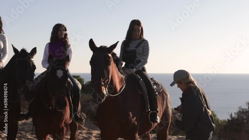 woman serving wine to friends riding horses