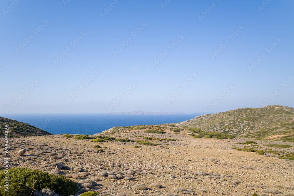 The arid countryside among the mountains , in Europe, Greece, Crete, towards Sitia, By the Mediterranean sea, in summer, on a sunny day.
