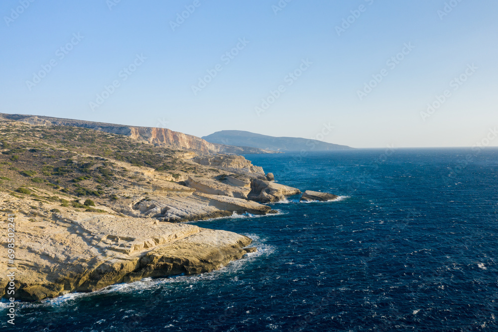 The arid rocky coast and its green countryside, in Europe, Greece, Crete, towards Matala, By the Mediterranean Sea, in summer, on a sunny day.