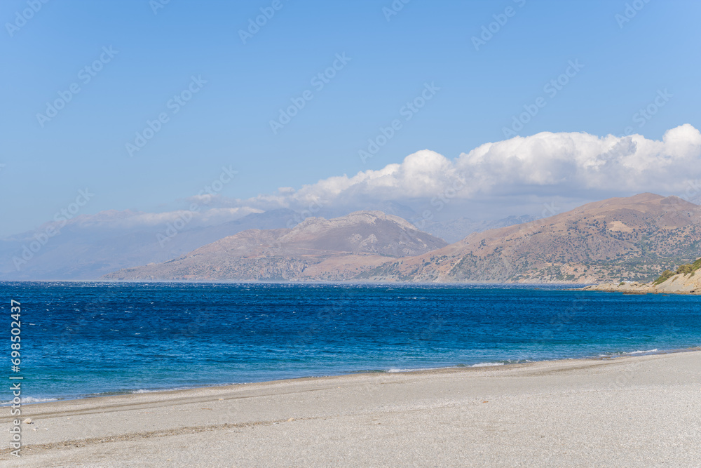 Triopetra Beach and the surrounding mountains, in Europe, in Greece, in Crete, towards Rethymno, At the edge of the Mediterranean Sea, in summer, on a sunny day.