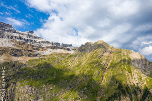 The barren rocky mountains in the middle of the countryside , Europe, France, Occitanie, Hautes-Pyrenees, in summer on a sunny day.