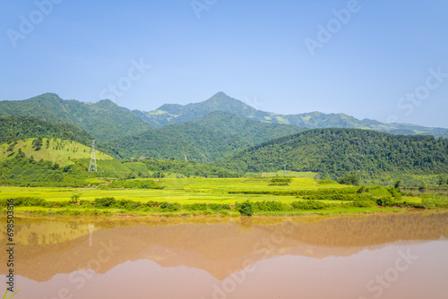 The red river in the middle of the green mountains, in Asia, Vietnam, Tonkin, between Dien Bien Phu and Lai Chau, in summer, on a sunny day. photo