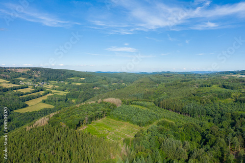 The countryside with its forests and green fields in Europe, France, Burgundy, Nievre, towards Chateau Chinon, in summer, on a sunny day.
