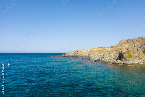 The arid rocky coast in Europe, France, Occitanie, Pyrenees Orientales, Banyuls-sur-Mer, By the Mediterranean Sea, in summer, on a sunny day. © Florent