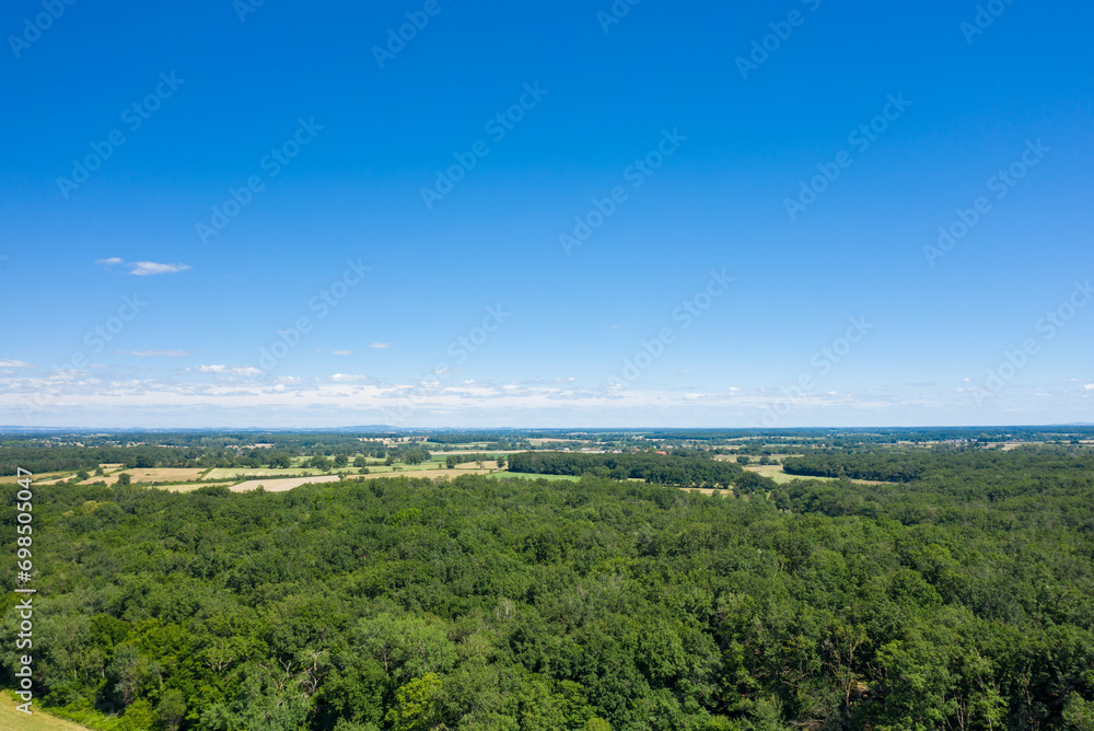 The green countryside with its forests and fields in Europe, France, Burgundy, Nievre, towards Nevers, in summer, on a sunny day.