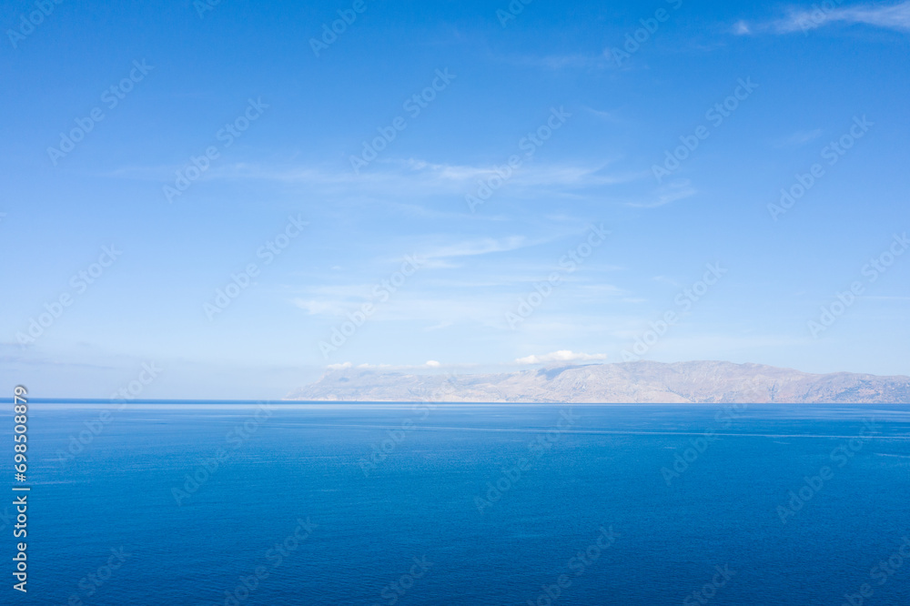 The mountainous coast, in Europe, in Greece, in Crete, towards Kissamos, towards Chania, By the Mediterranean Sea, in summer, on a sunny day. The mountainous coast, in Europe, in Greece, in Crete, towards Kissamos, towards Chania, By the Mediterranean Sea, in summer, on a sunny day.