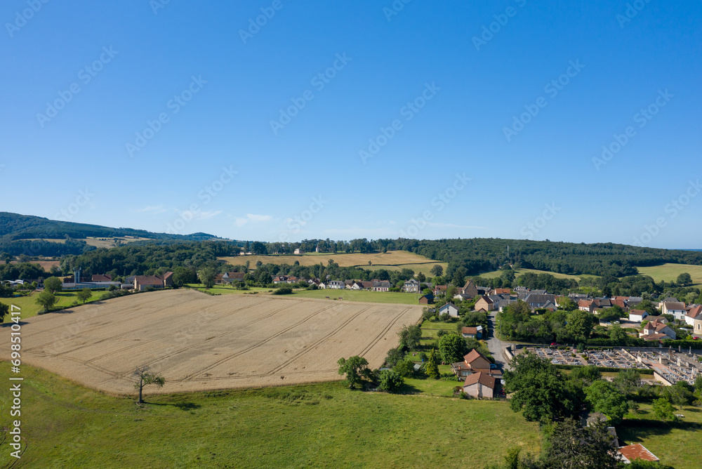 Obraz premium A traditional village old seaside resort in the middle of the countryside in Europe, France, Burgundy, Nievre, Saint-Honoré-les-Bains, towards Chateau Chinon, in summer on a sunny day.