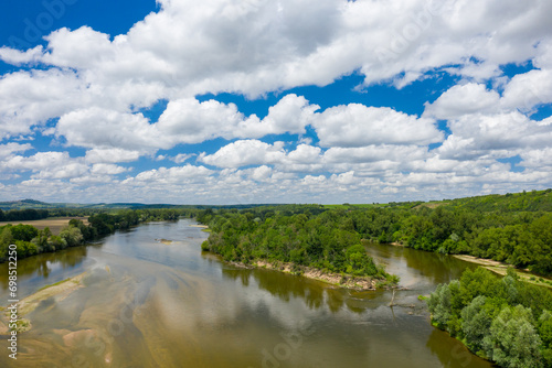 Loire river in the middle of green countryside in Europe, France, Burgundy, Nievre, Pouilly sur Loire, towards Nevers, in summer, on a sunny day. photo