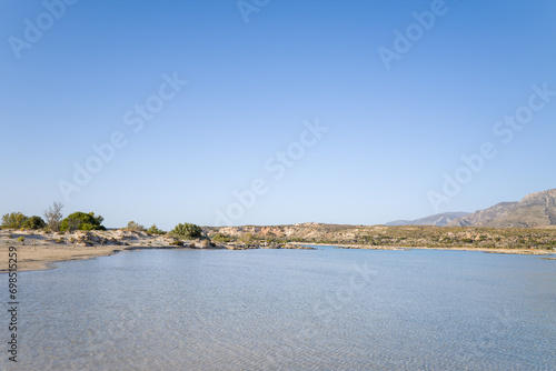 The sandy beach and its heavenly colored water, in Europe, Greece, Crete, Elafonisi, By the Mediterranean Sea, in summer, on a sunny day.