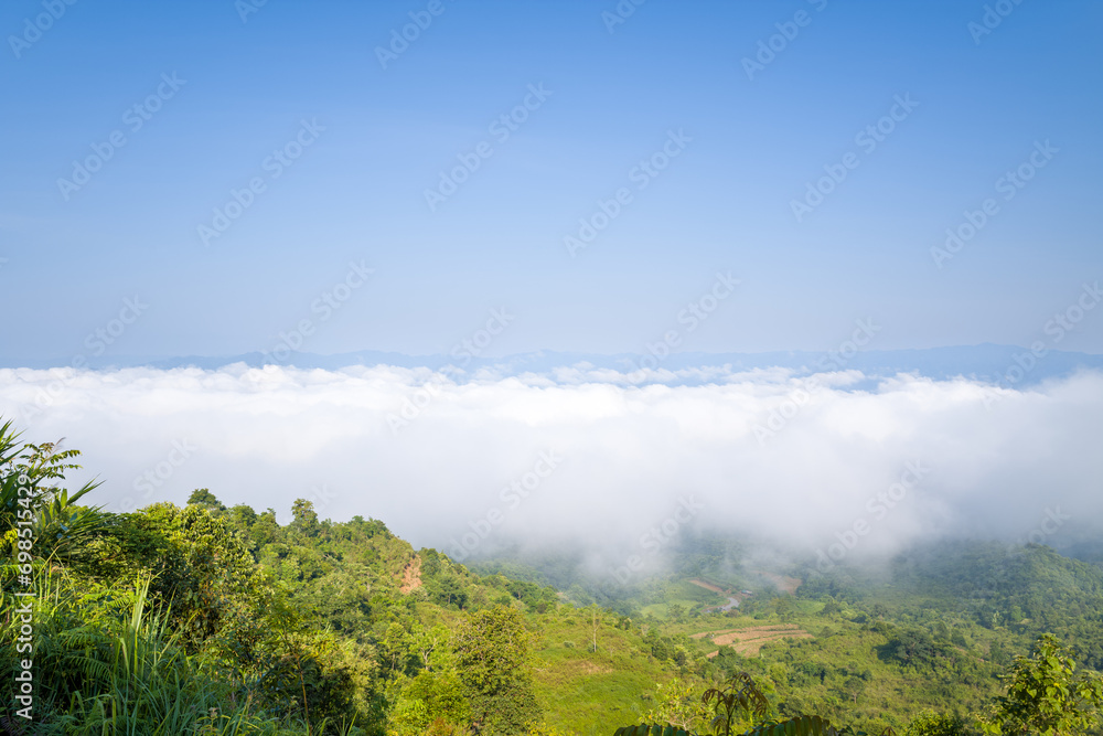 The clouds above the city seen from the green mountains , in Asia, Vietnam, Tonkin, Dien Bien Phu, in summer, on a sunny day.