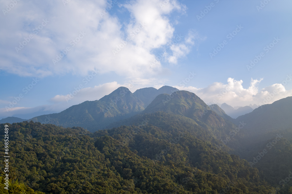 The Fan Si Pan massif and its green mountains, in Asia, in Vietnam, in Tonkin, towards Sapa, in summer, on a sunny day.