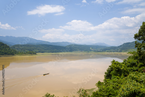 The red river in the middle of the green mountains, in Asia, Vietnam, Tonkin, between Dien Bien Phu and Lai Chau, in summer, on a sunny day. photo