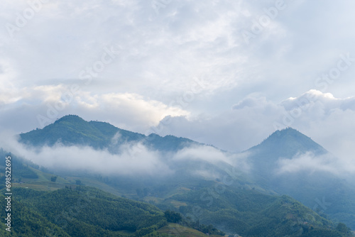 The green mountains, in Asia, in Vietnam, in Tonkin, in Sapa, towards Lao Cai, in summer, on a cloudy day.