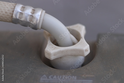 Closeup shot of a Washing machine inlet or outlet pipe attached to a washing machine, closeup