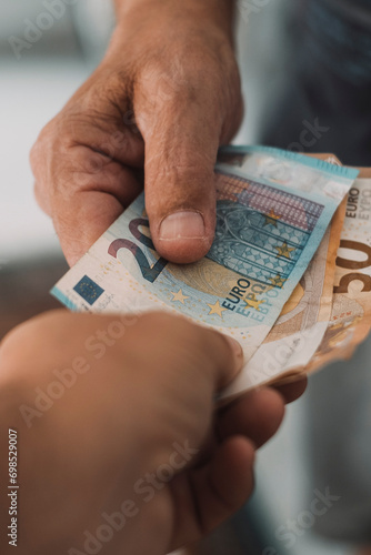 Close up of people exchanging cash banknote money. Concept of giving and taking euros. Economy and business. Present and loan back. Banking financial. Paying bills or credit action. One man give money