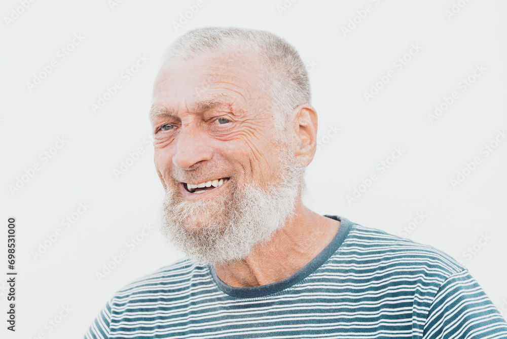 75 year old senior man laughs while having a good time outdoors. 75 year old senior man laughs while having a good time outdoors.