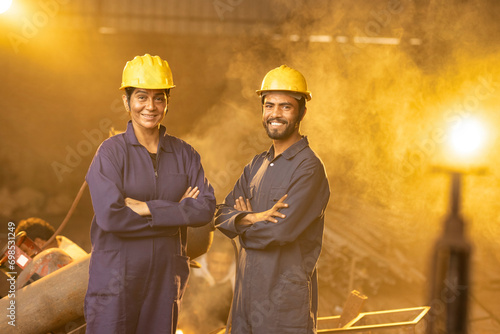 Photography Two confident industrial workers in protective workwear at factory