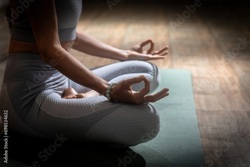 Beautiful woman practices kundalini yoga indoors. Wise