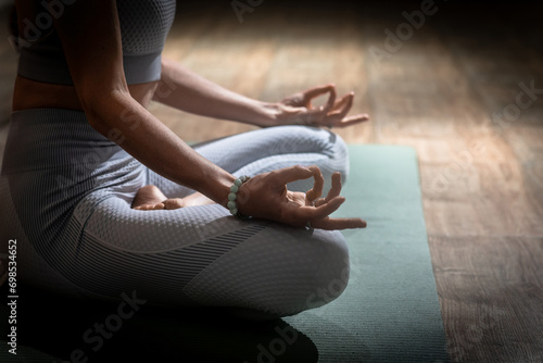 Beautiful woman practices kundalini yoga indoors. Wise photo