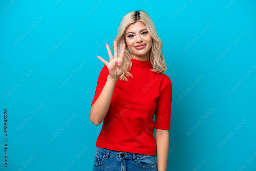 Young Russian woman isolated on blue background happy and counting four with fingers Young Russian woman isolated on blue background happy and counting four with fingers