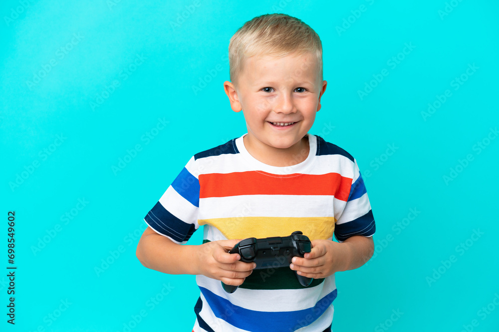 Little Russian boy playing with a video game controller over isolated background Little Russian boy playing with a video game controller over isolated background