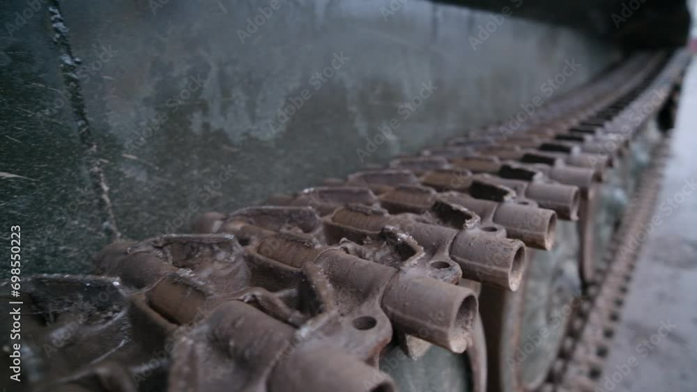 Tank track close-up. Top of the track. a fragment of the details of the tank track. Tank track close-up. Top of the track. a fragment of the details of the tank track.