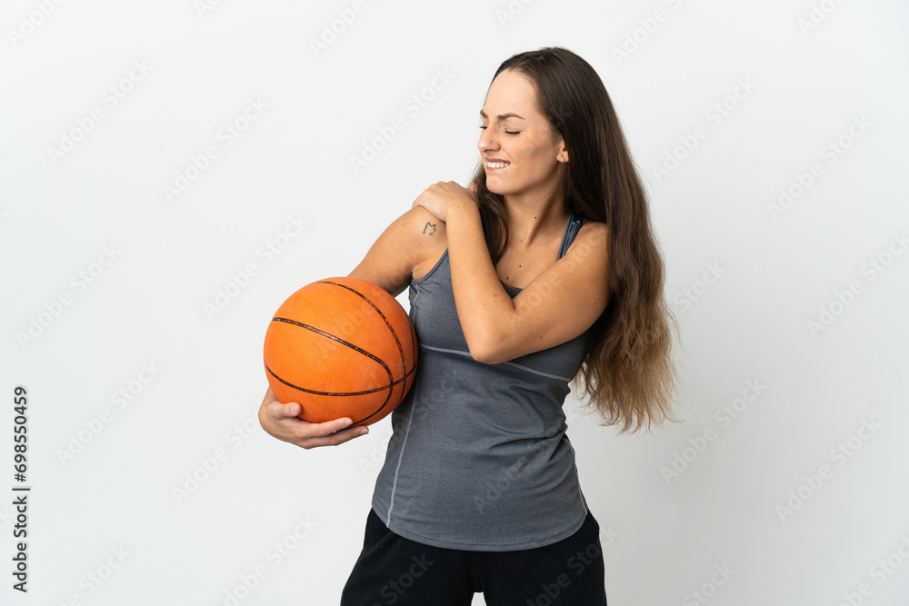 Young woman playing basketball over isolated white background suffering from pain in shoulder for having made an effort