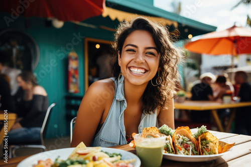 Young Mexican Woman Enjoying Tacos At Outdoor Mexica Restaurant