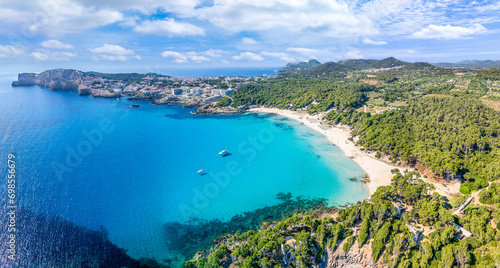 Aerial view of Cala Agulla and beautiful coast at Cala Ratjada, Mallorca: pristine beach, crystal waters, surrounded by nature, perfect Mediterranean escape.