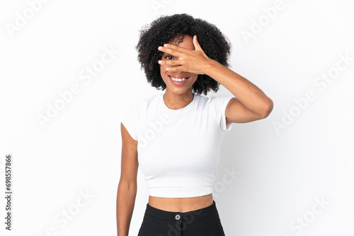 Young African American woman isolated on white background covering eyes by hands and smiling