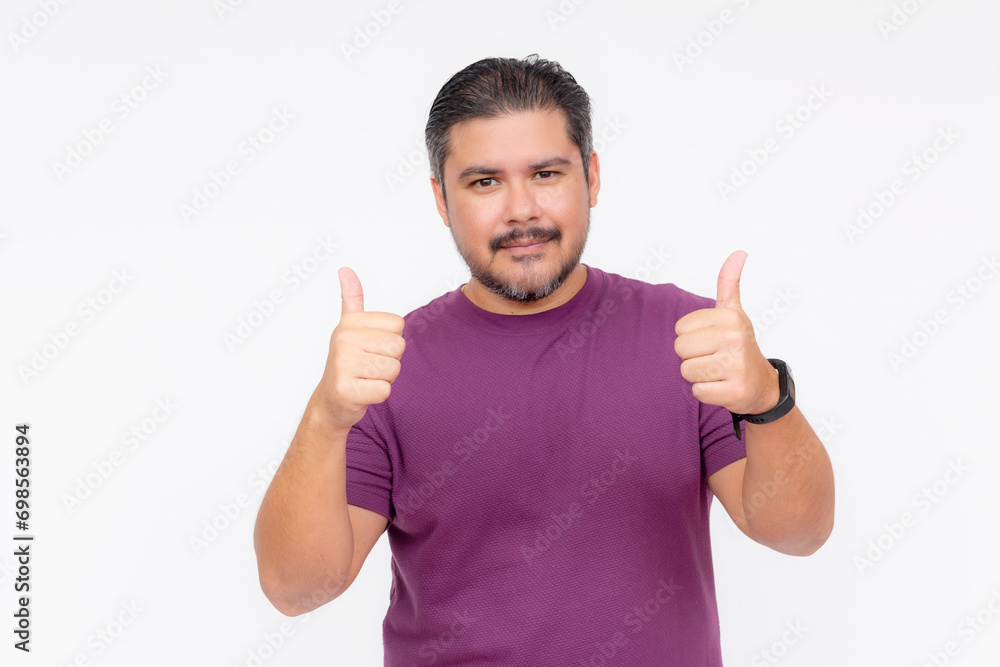 Portrait of a chubby bearded guy making the thumbs up sign with both hands. Wearing a purple waffle shirt. Half body photo isolated on white background. Portrait of a chubby bearded guy making the thumbs up sign with both hands. Wearing a purple waffle shirt. Half body photo isolated on white background.
