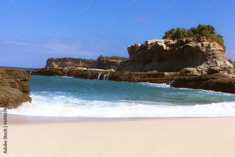 Beautiful beach with waves breaking on the rocks, Pacitan Klayer, East Java, Indonesia
