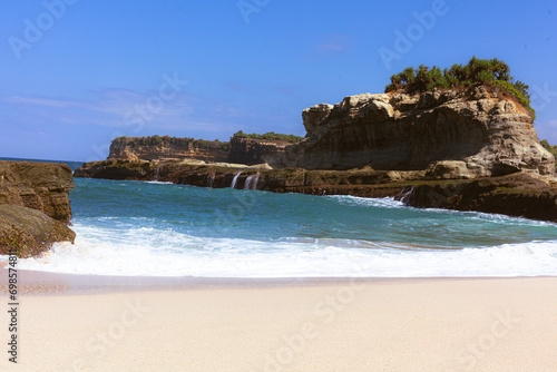 Beautiful beach with waves breaking on the rocks, Pacitan Klayer, East Java, Indonesia
