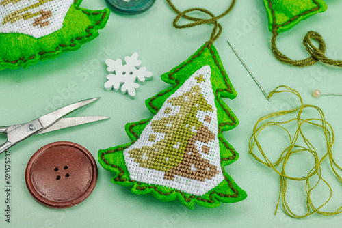 Traditional New Year composition.Festive handmade decor, Christmas trees embroidered with a cross photo