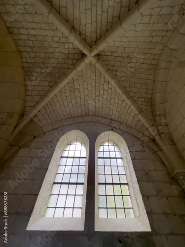 Light shines through the old  windows in an monastery in France