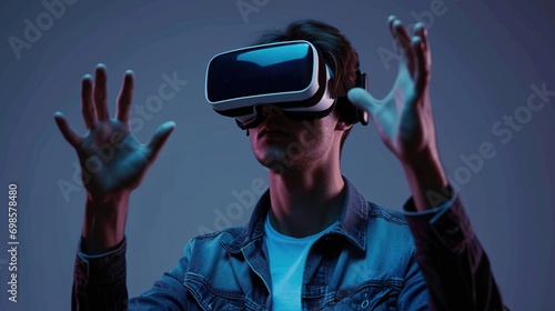 Young man using virtual reality headset isolated on gray background, VR, future gadgets, technology, virtual event, education © WS Studio 1985