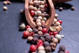 Different kind of Peppercorns in a wooden spoon.Different kind of Peppercorns in a wooden spoon