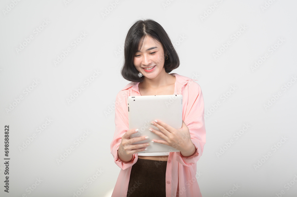 Young asian woman using tablet over white background, technology concept Young asian woman using tablet over white background, technology concept