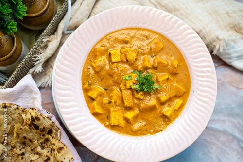 Famous Paneer Mumtaj or Mamtaj curry in a ceremic plate served with naan or roti. photo
