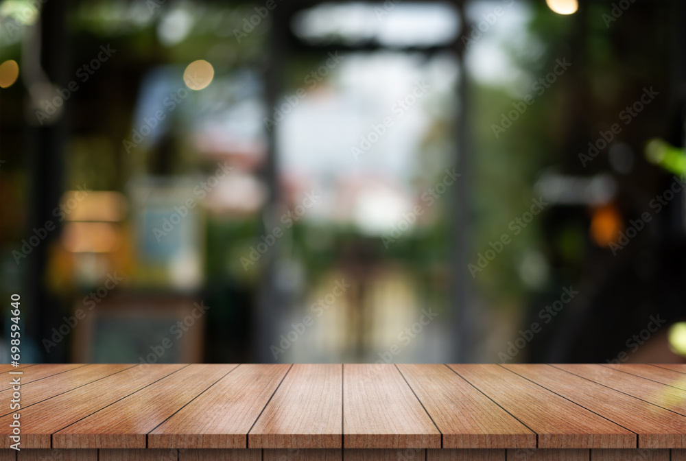 Empty wooden table top with lights bokeh on blur restaurant background. Empty wooden table top with lights bokeh on blur restaurant background.
